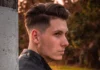Man with low taper fade haircut.