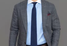 A man wearing a blue shirt & gray suit