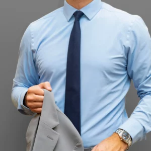 man wearing a blue shirt with a grey suit