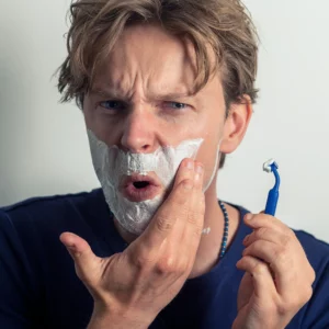 A man shaving with a bad razor