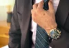 man wearing a watch & suit