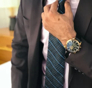 man wearing a watch & suit